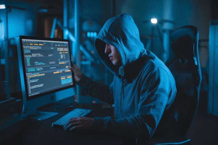 Illustration d'une cyberattaque bancaire Un hacker accède à des données bancaires sur un ordinateur